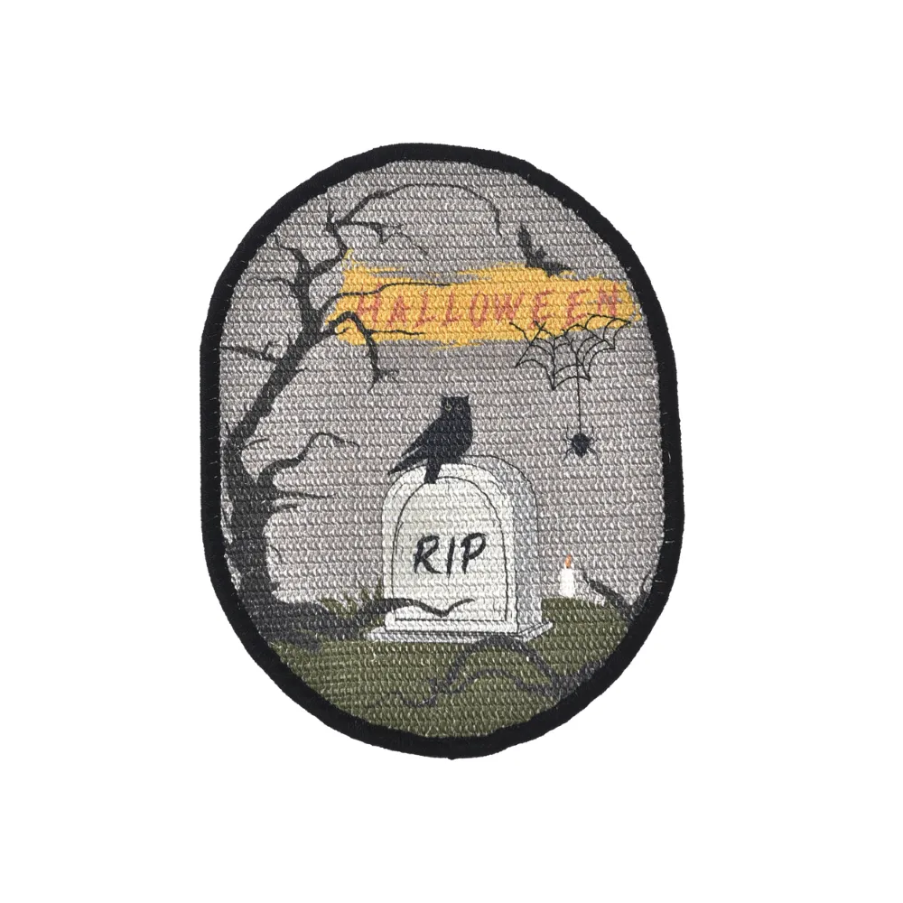 Front view of an oval cat scratching pad featuring a spooky graveyard scene with a "RIP" tombstone, an owl, and "Halloween" text.