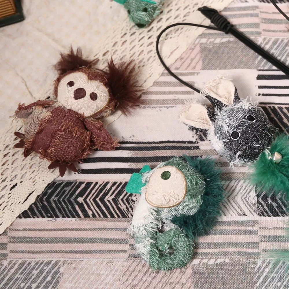 Collection of petfairs hippie series plush toys including an owl chameleon and rabbit on a rug.