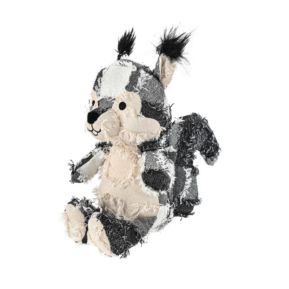 Gray and white shaggy patchwork squirrel plush dog toy with black tufted ears on a white background.