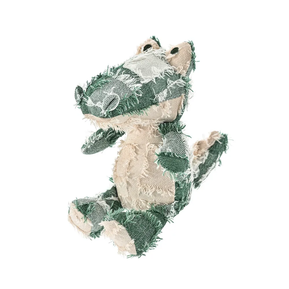 Green shaggy patchwork alligator plush dog toy with yarn dyed plaid texture on a white background.