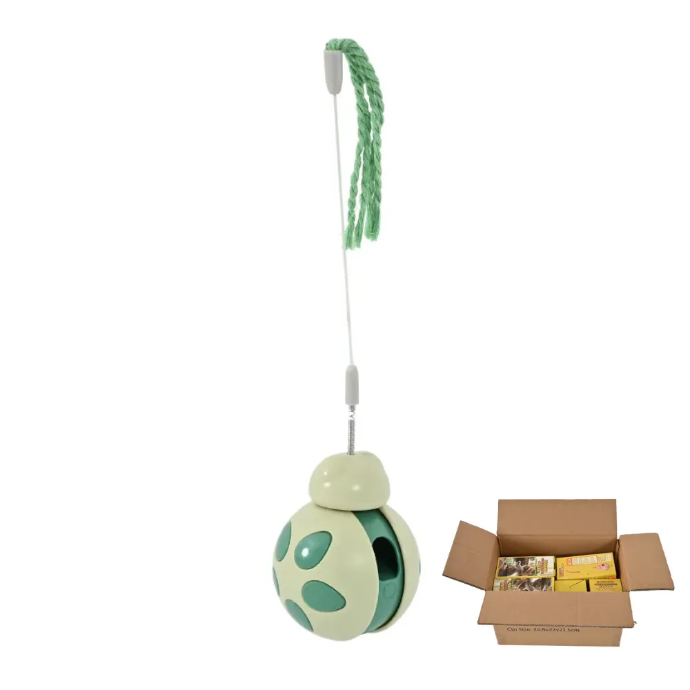 A green 2-in-1 cat teaser ball toy next to a cardboard shipping box filled with packaged products.