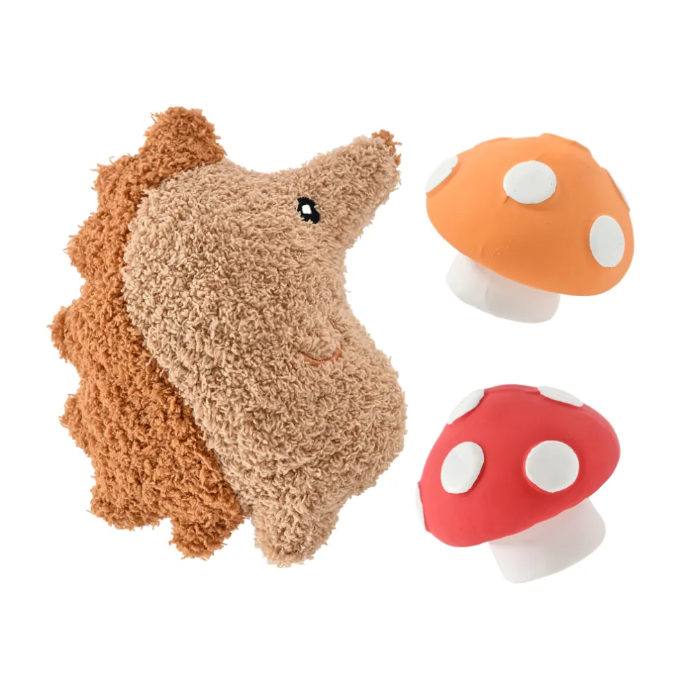 High-quality studio shot of a brown plush hedgehog toy and two squeaky latex mushrooms against a white background.