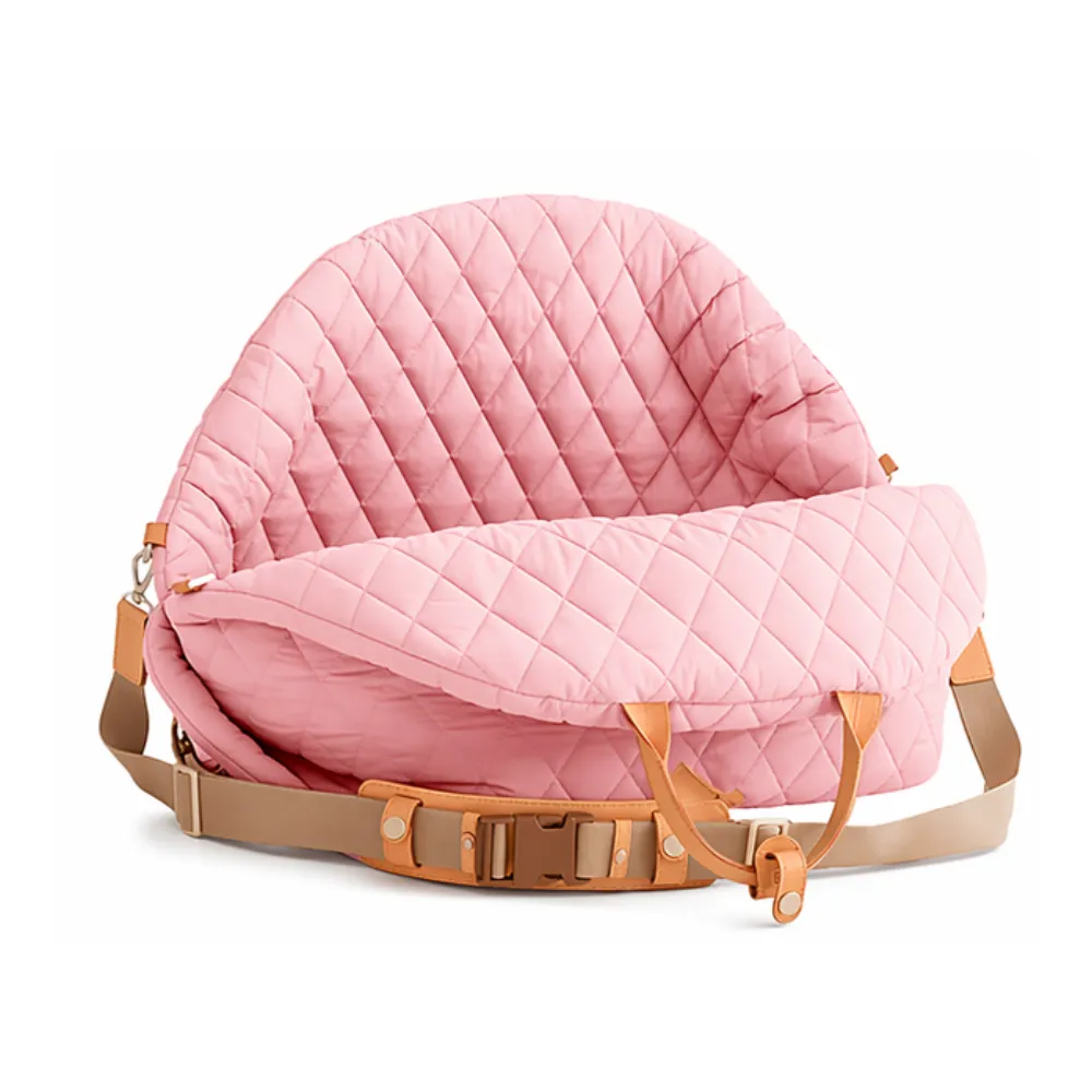 pink quilted portable dog car seat bag with adjustable shoulder strap and leather handles on white background
