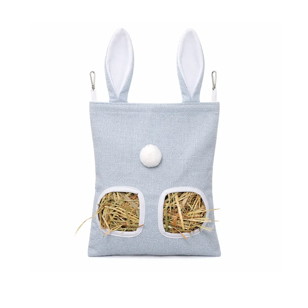 A pale blue hanging hay storage bag for rabbits and guinea pigs featuring a white pom-pom tail and metal clips.