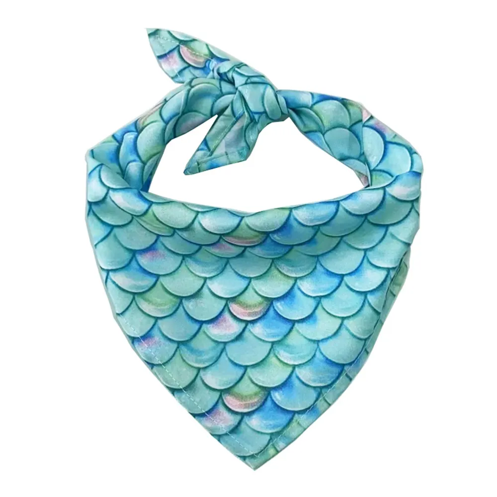 A vibrant teal and green dog bandana with a shimmering mermaid fish scale pattern.