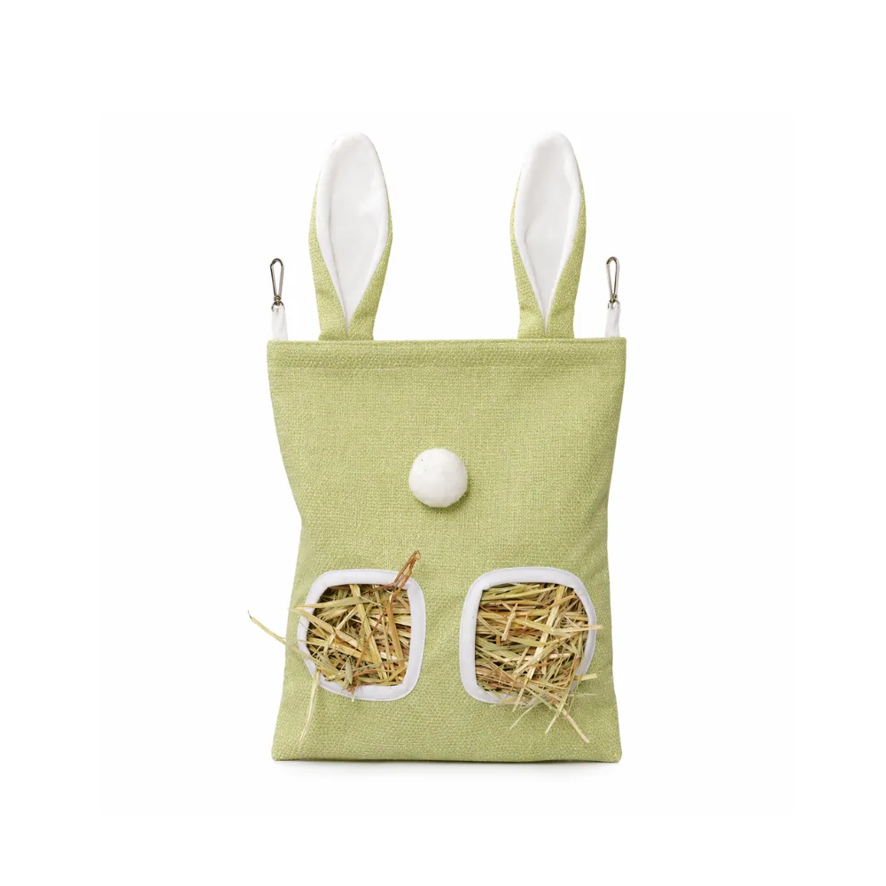Front view of a light green fabric hay feeder bag with two feeding windows, white trim, and decorative bunny ears.
