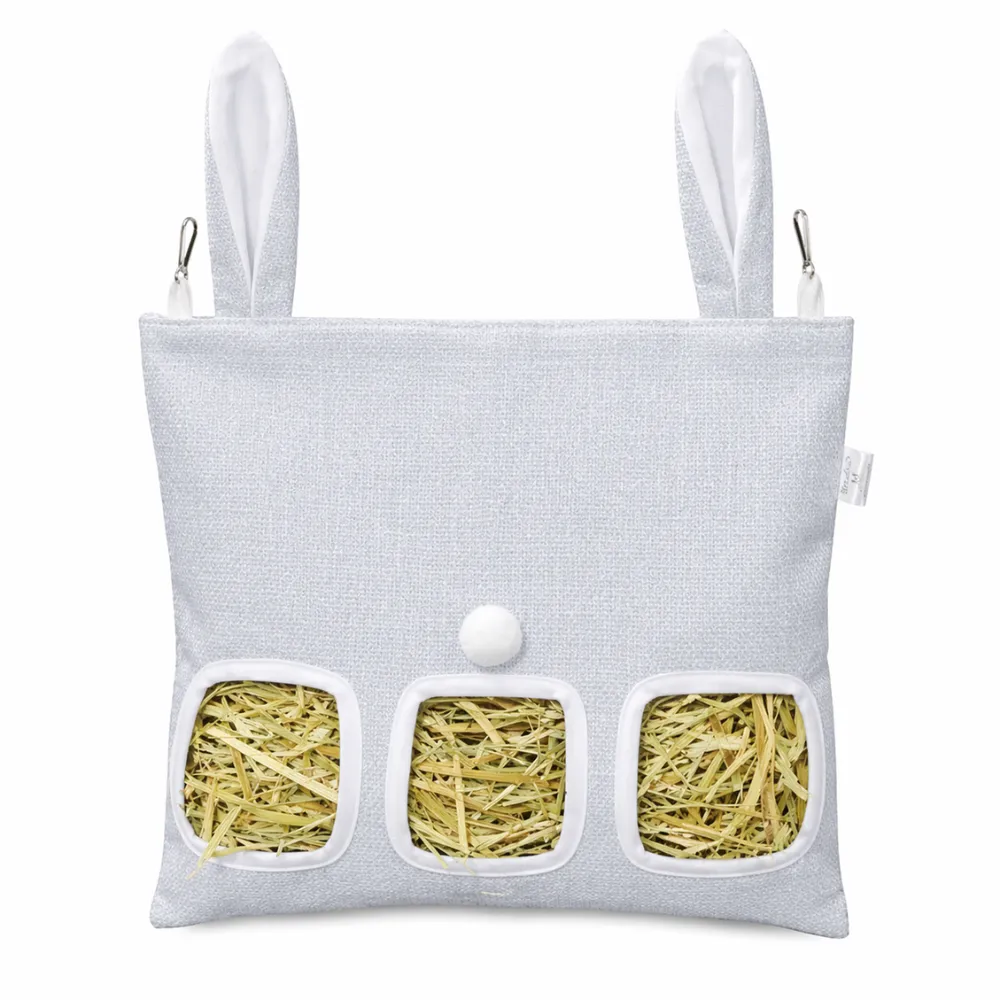Front view of a light blue-grey hay feeder bag with decorative bunny ears and metal clips.