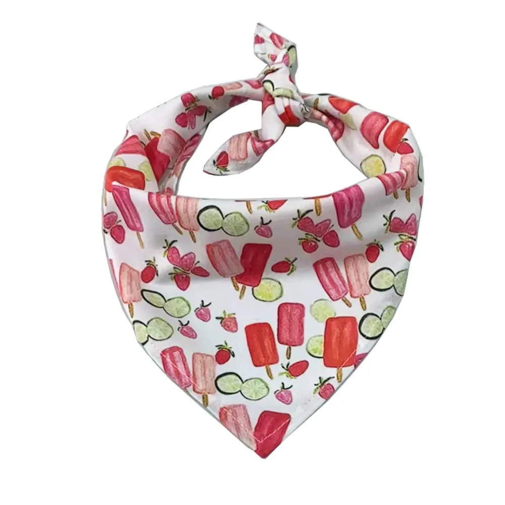 A white dog bandana decorated with colorful pink and red popsicles, strawberries, and lime slices.
