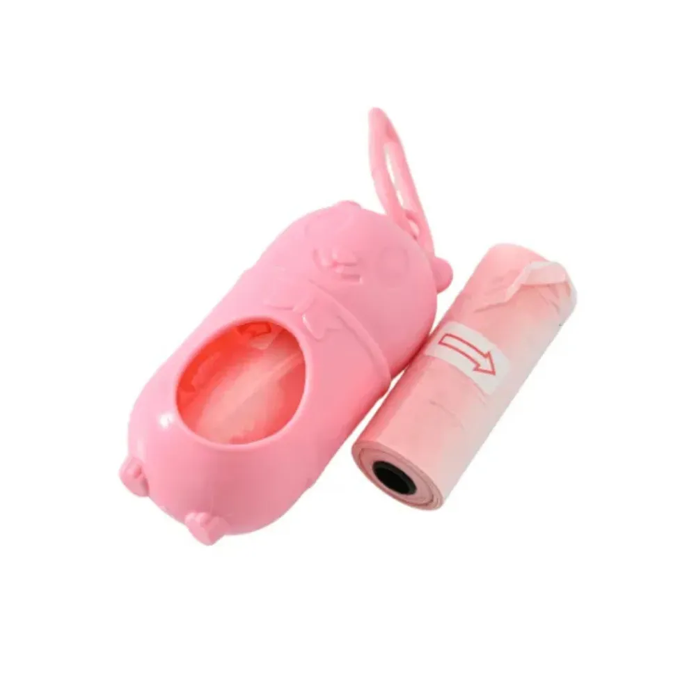 Close-up of the pastel pink bear-shaped pet waste bag dispenser with one pink refill roll showing a directional arrow.