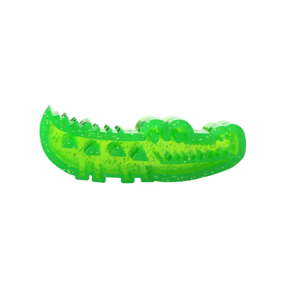 Side view of a green glittery crocodile dog toy showing the 3D dental cleaning textures and ridges.