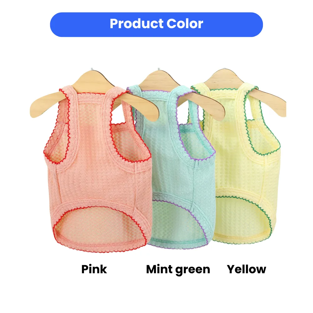 A collection of pink, mint green, and yellow mesh dog tank tops on wooden hangers against a green background.