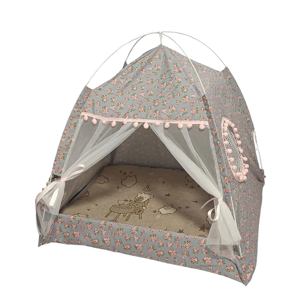 Grey Floral Cat Tent with Pink Accents A grey floral patterned pet tent with pink pom poms and sheer privacy curtains isolated on a white background.