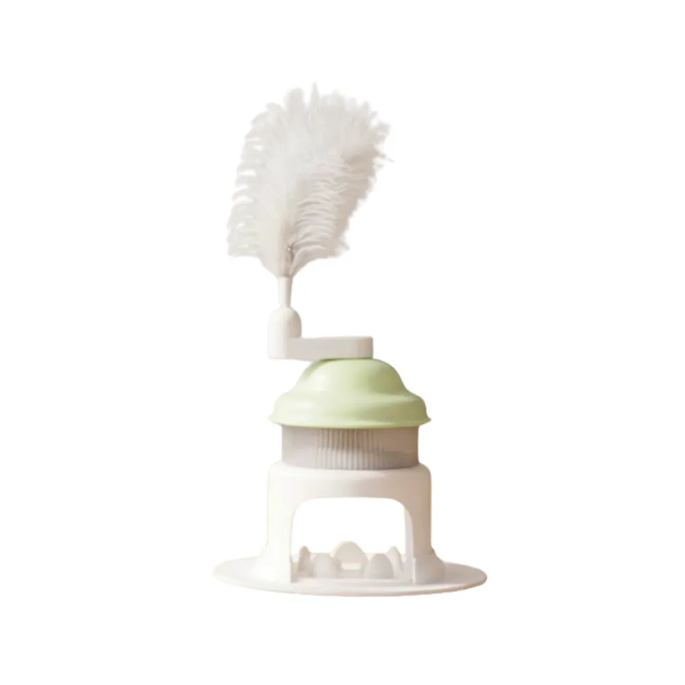 Green rotating cat treat dispenser toy with feather wand isolated on white background