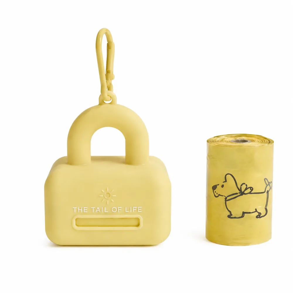 Yellow silicone dog poop bag dispenser with matching waste bag roll and clip attachment