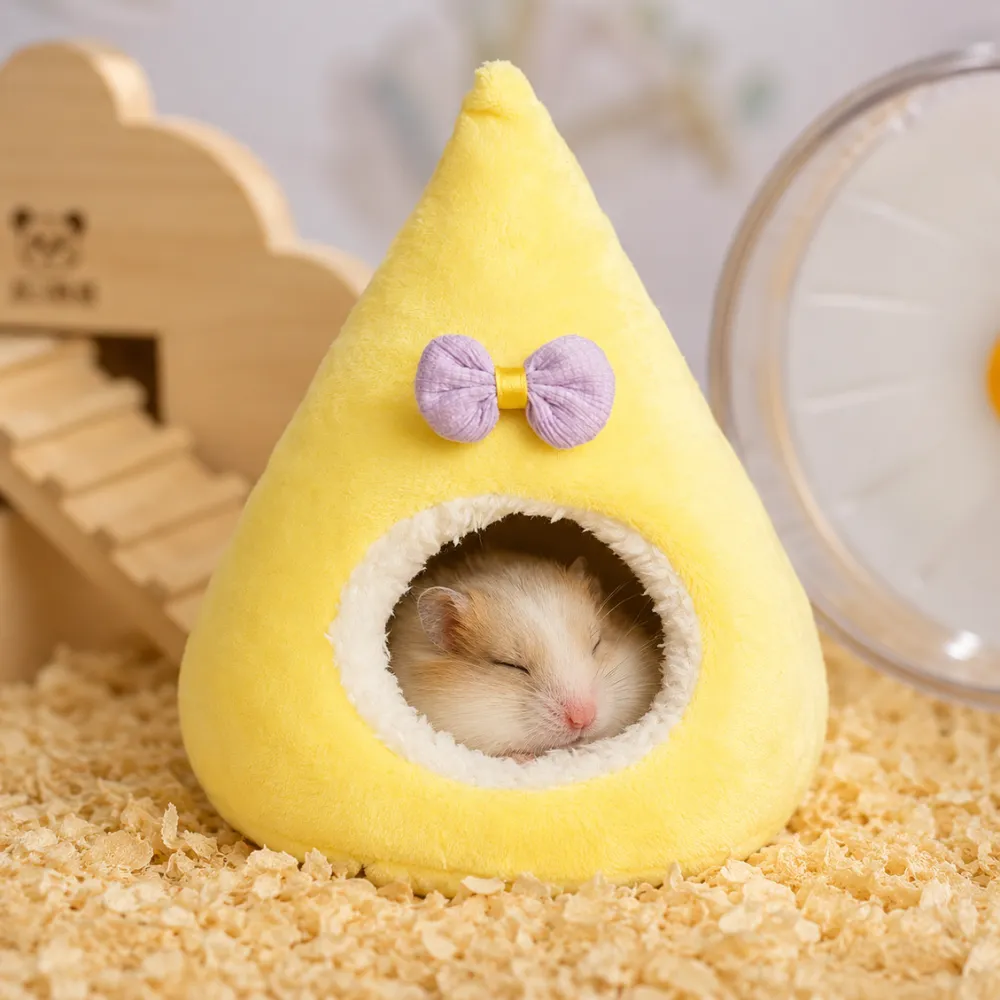 Cute hamster sleeping inside a warm plush hamster house and hideout