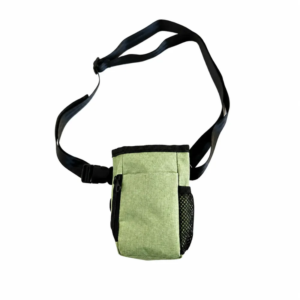Green dog training treat bag with adjustable strap and zippered compartment