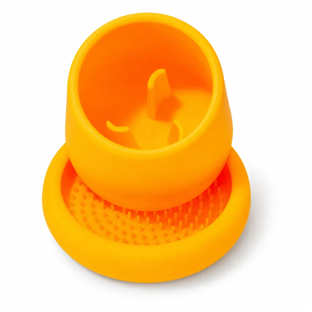 Orange slow feeder dog bowl designed with textured base and raised interior structure for slow eating