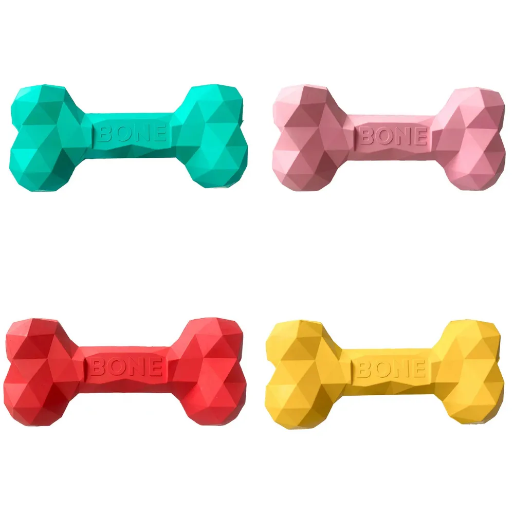 Green, pink, red, and yellow dog treat dispensing bone toys for chewing and interactive play