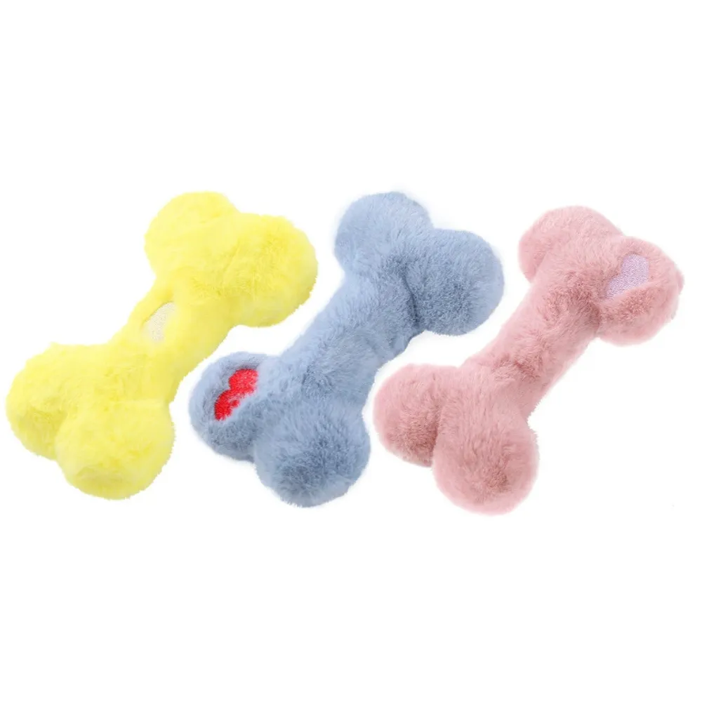 Yellow blue and pink plush bone dog toys for small dogs on white background