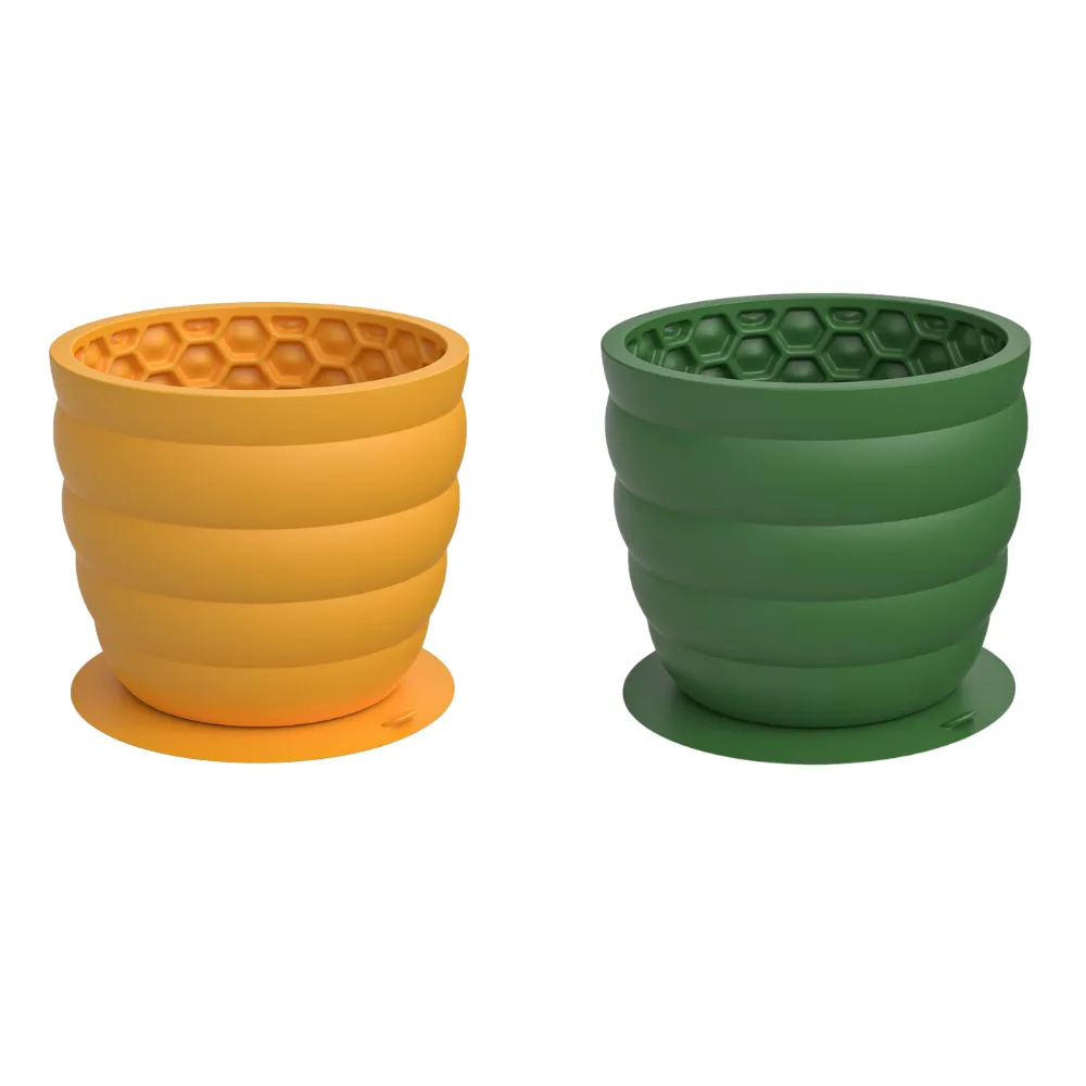 Yellow and green silicone honeycomb dog slow feeder cups with suction bases on white background