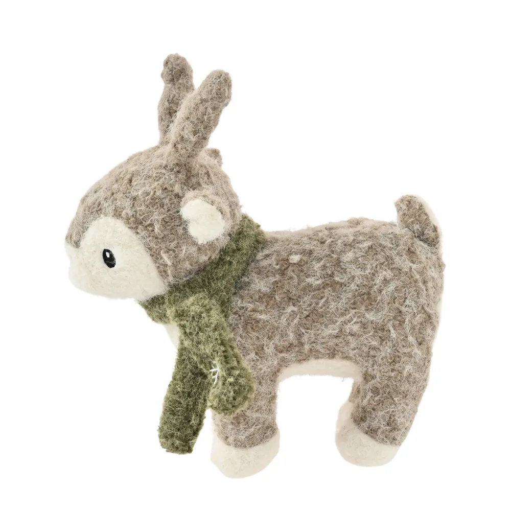 Side view of Christmas reindeer plush dog toy with green scarf on white background