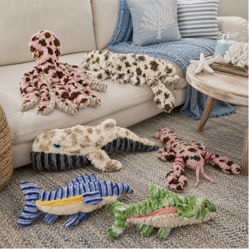 Ocean-themed dog plush toys displayed in a coastal living room scene
