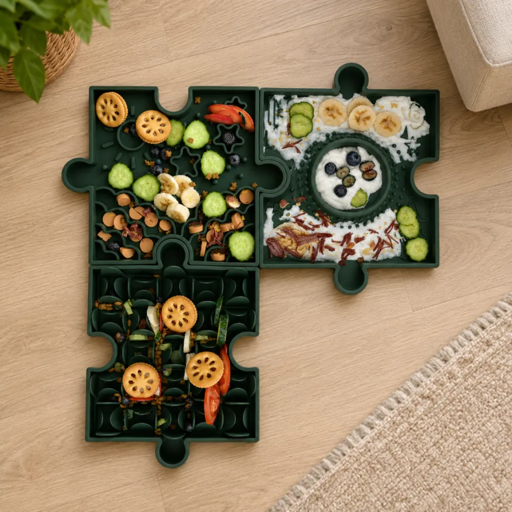 Three green puzzle slow feeder bowls connected on a living room floor with fresh food and dog treats.
