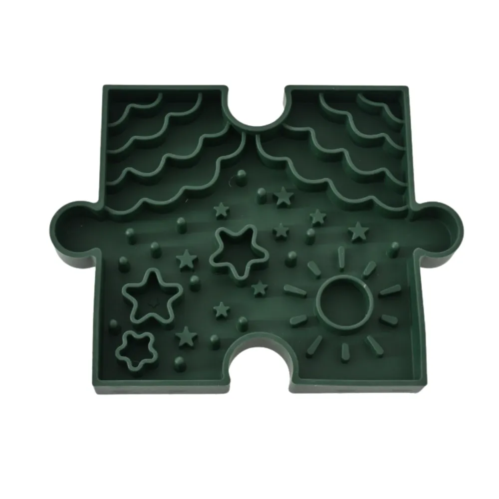 Green Puzzle Dog Slow Feeder Bowl White Background Green puzzle dog slow feeder bowl with raised patterns, star shapes, and food maze design on white background.