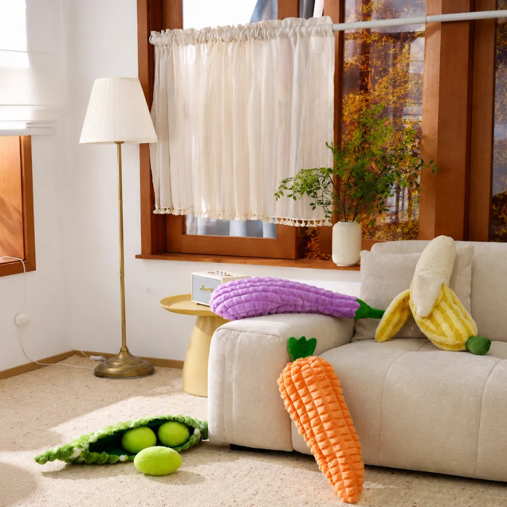Banana plush dog toy with colorful vegetable plush toys in home setting